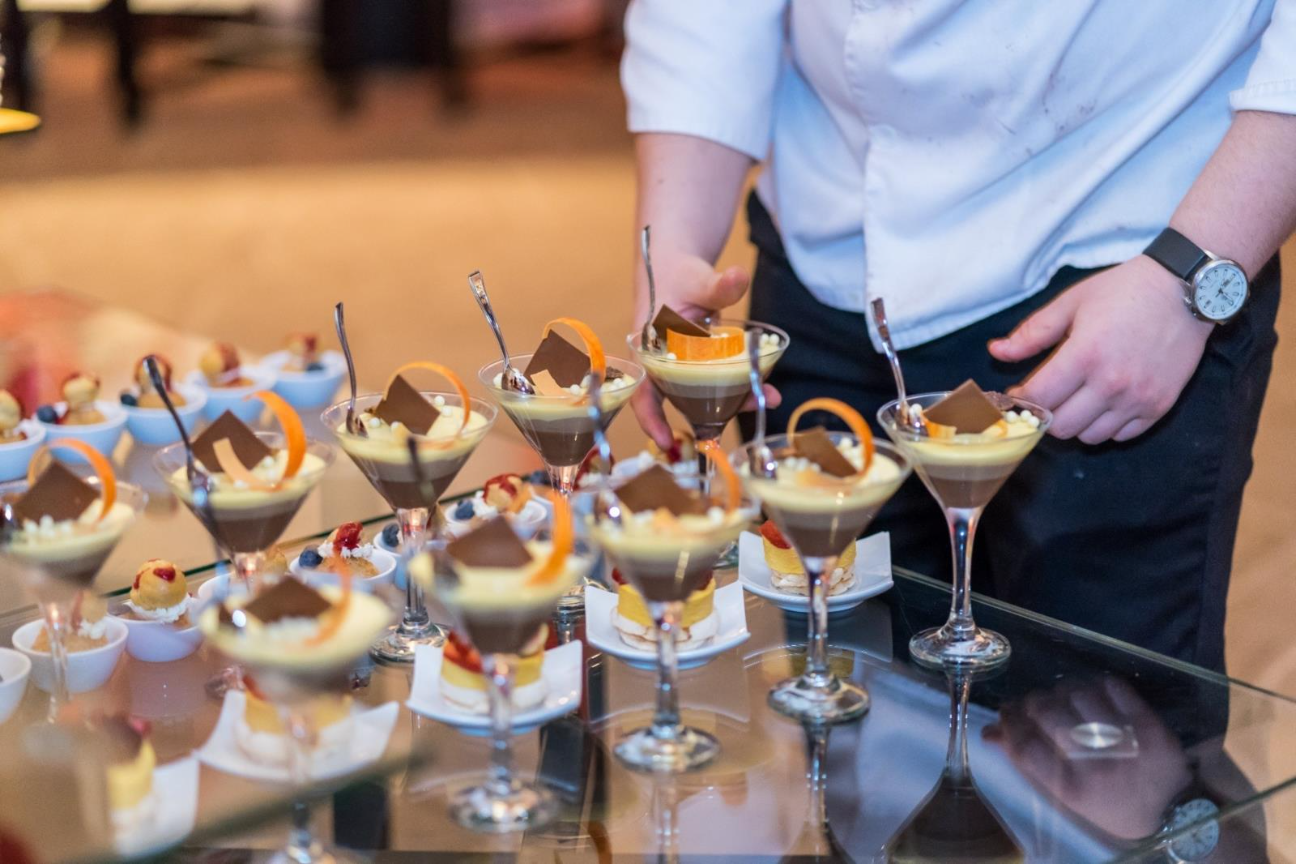 A group of glasses of dessertsAI-generated content may be incorrect.